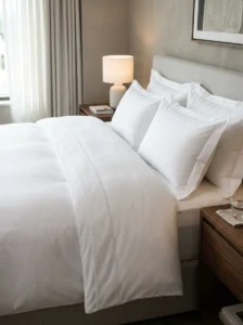 Deep-pocket fitted sheet creating a smooth foundation for hotel-style bedding.