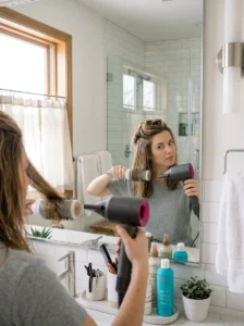 Alt Text: Practicing salon-style blow drying at home.
