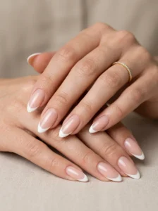 Almond-shaped French tip nails showing an elongated tapered silhouette
