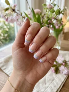 Pastel spring manicure with a scattered dot accent nail.