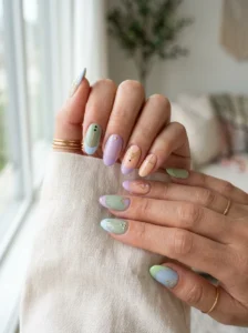 Playful spring manicure combining pastel colors, gingham, gold stars, French tips, and ombre.