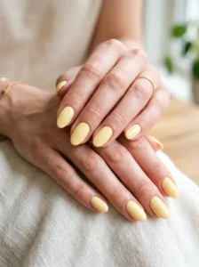 Soft buttery yellow spring manicure with a glossy finish.