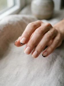 Minimalist and negative-space French tip designs on short nails