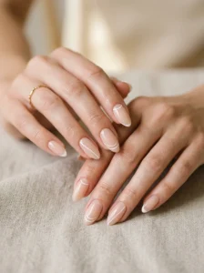 Minimalist negative-space French designs on almond-shaped nails
