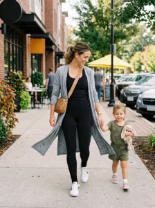 Mom wearing a long cardigan over leggings and a fitted athletic top with sneakers.
