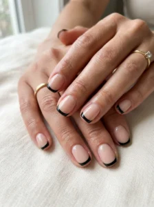 Short nude nails with clean black French tips