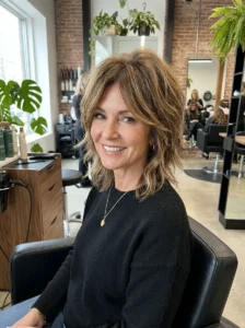Textured pixie shag haircut with crown volume for a woman over 50.
