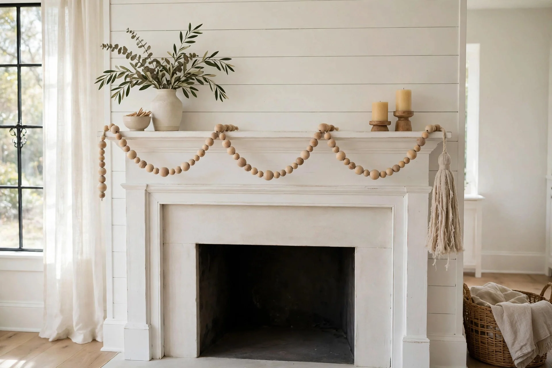 Natural wood bead garland with a linen tassel draped across a white mantel